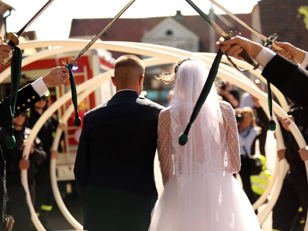 Druhowie na ślubnym kobiercu. Musieli przeciąć strażacki wąż!