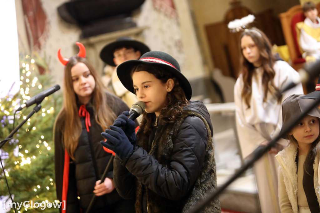 Dzieci pod stajenką z kocami i poduszkami